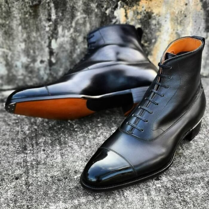 Step into sophistication with our men's stylish black cowhide leather ankle high cap toe lace-up boots. Ideal for any occasion, they redefine modern elegance.