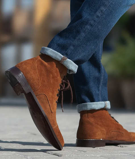 Brown suede boots with rolled up jeans.