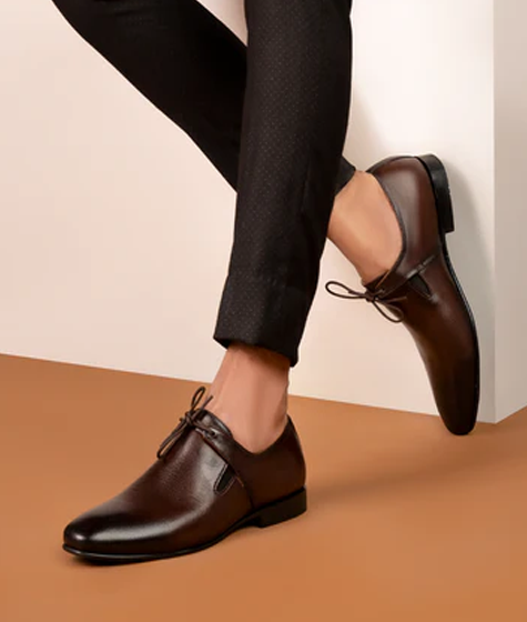 Man wearing stylish brown leather dress shoes